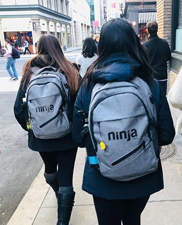 NinjaOne team members with logo backpack