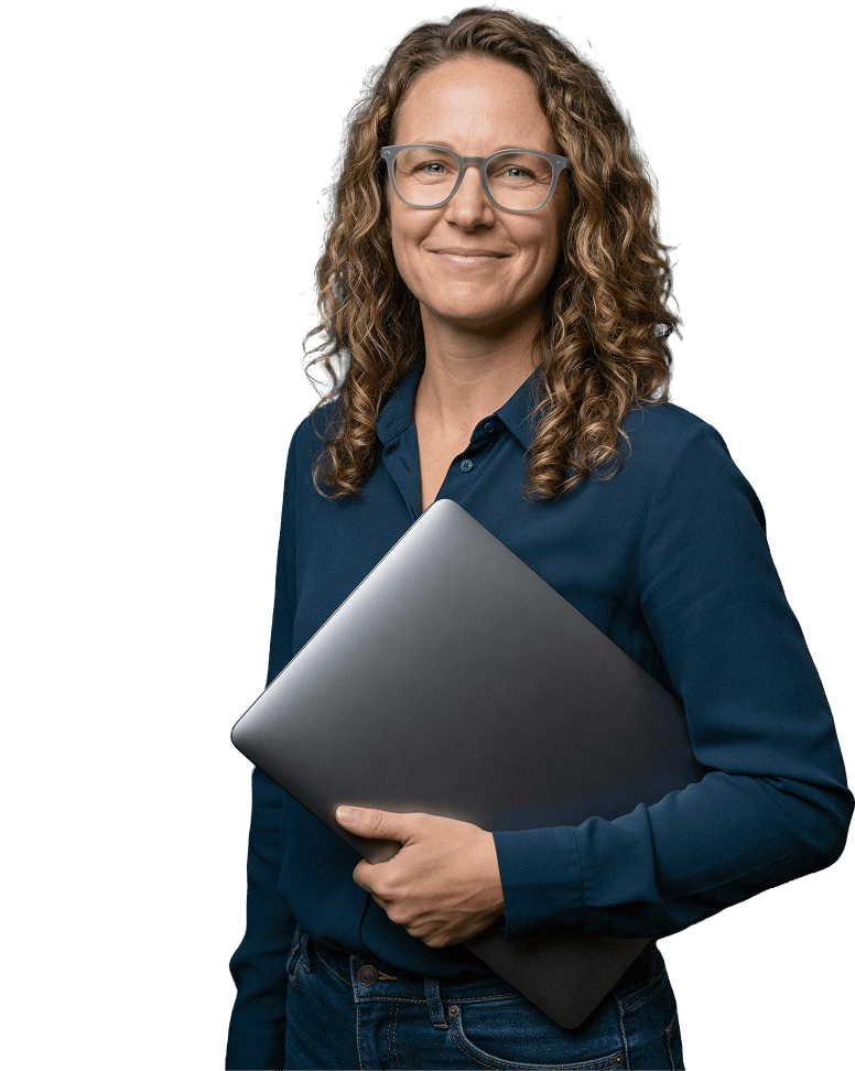 usecases-automate-hero-p1-1 IT professional smiling and holding a laptop, representing NinjaOne automation use cases