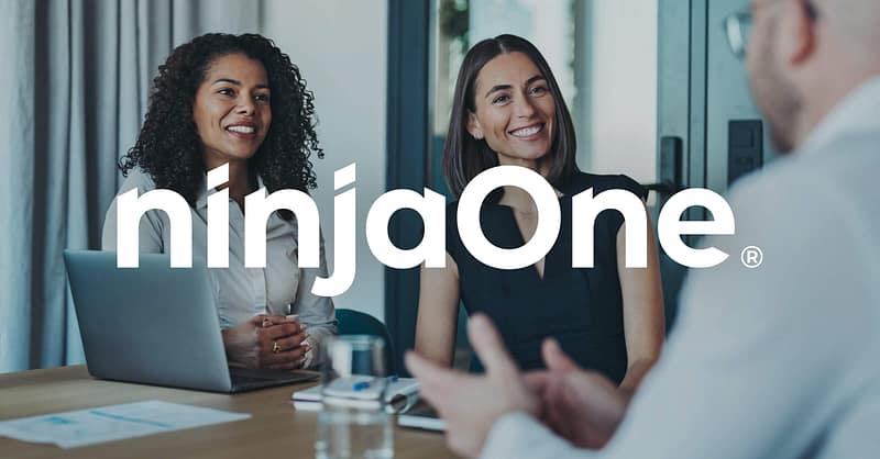 NinjaOne Named to the Deloitte Technology Fast 500 – Again! coworkers sitting at a table together talking and smiling