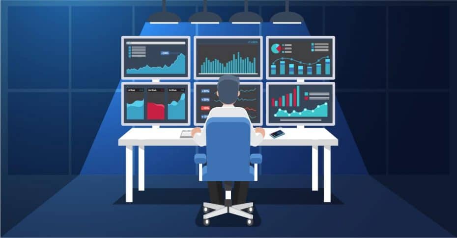 SysAdmin or IT professional sitting in front of workstation with several monitors representing a Network Operations Center (NOC)